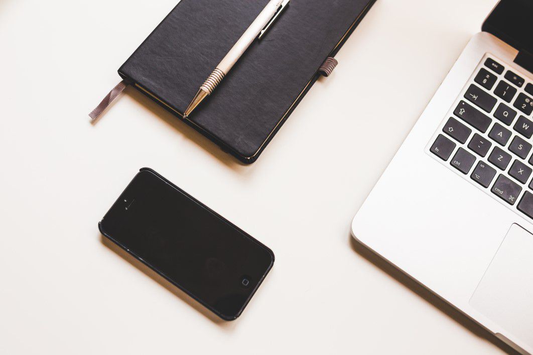 Black iPhone, MacBook & Notepad