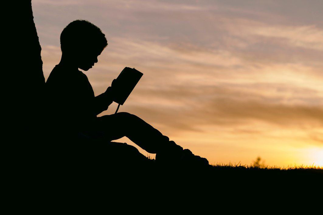 Silhouette Child Reading Sunset