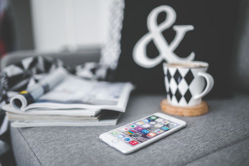 iPhone on Couch With Magazines