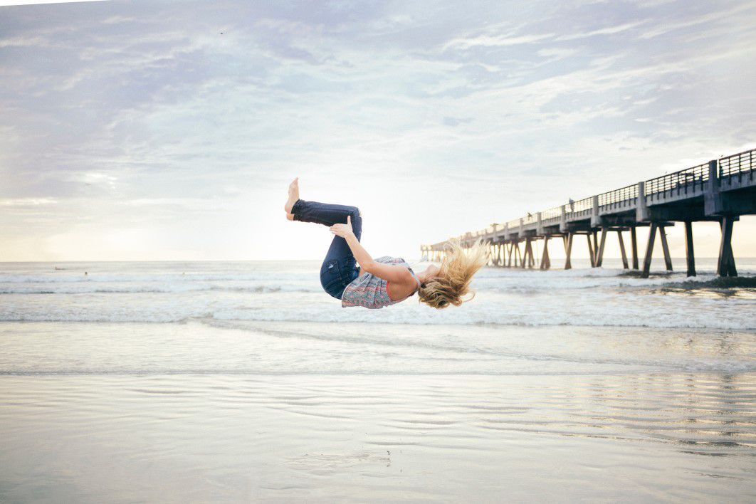 Woman Jumping Beach Sunset
