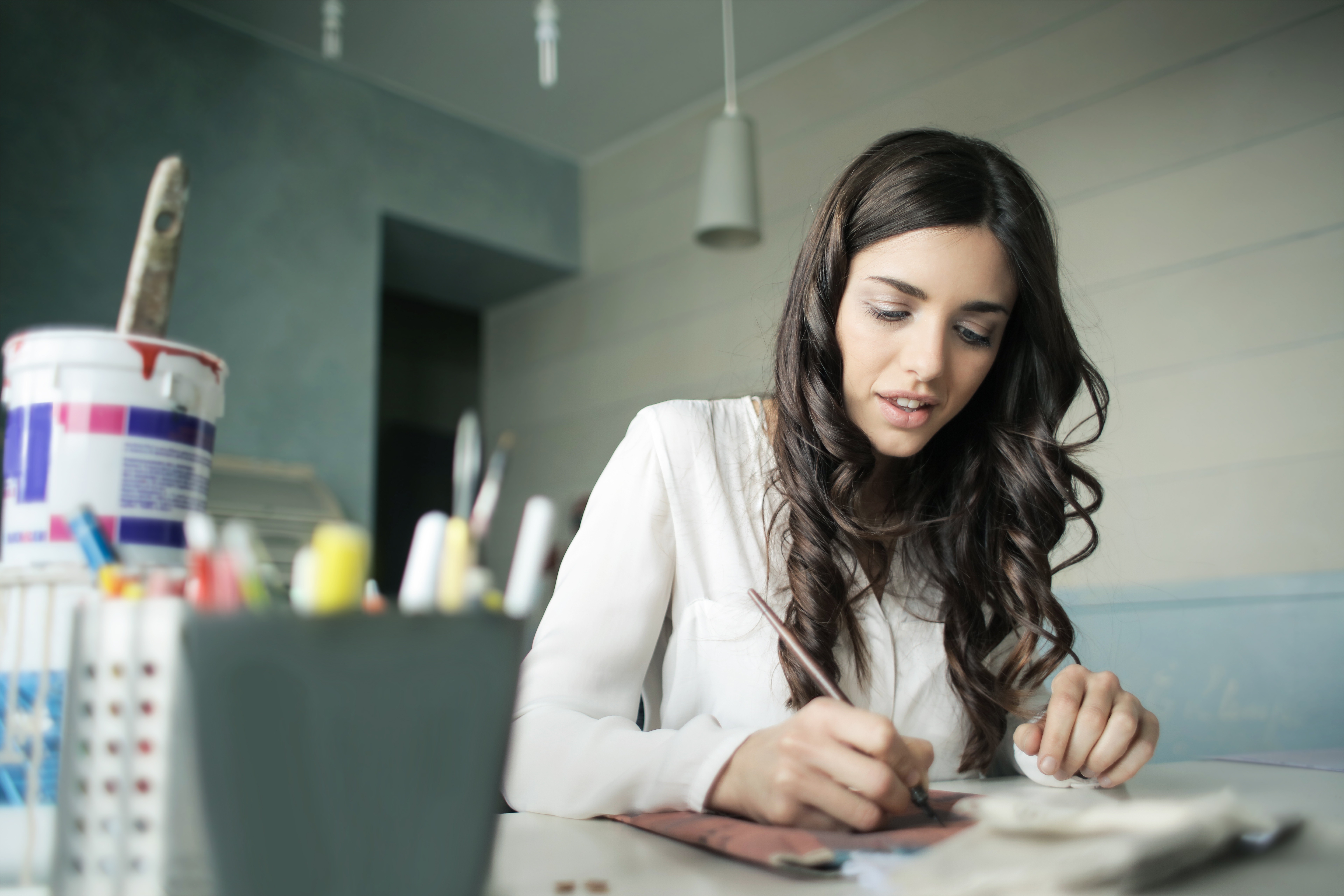 Young Woman Painting Desk