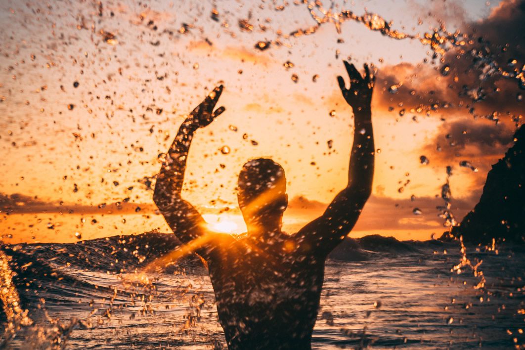 Man Splashing Water Sunset