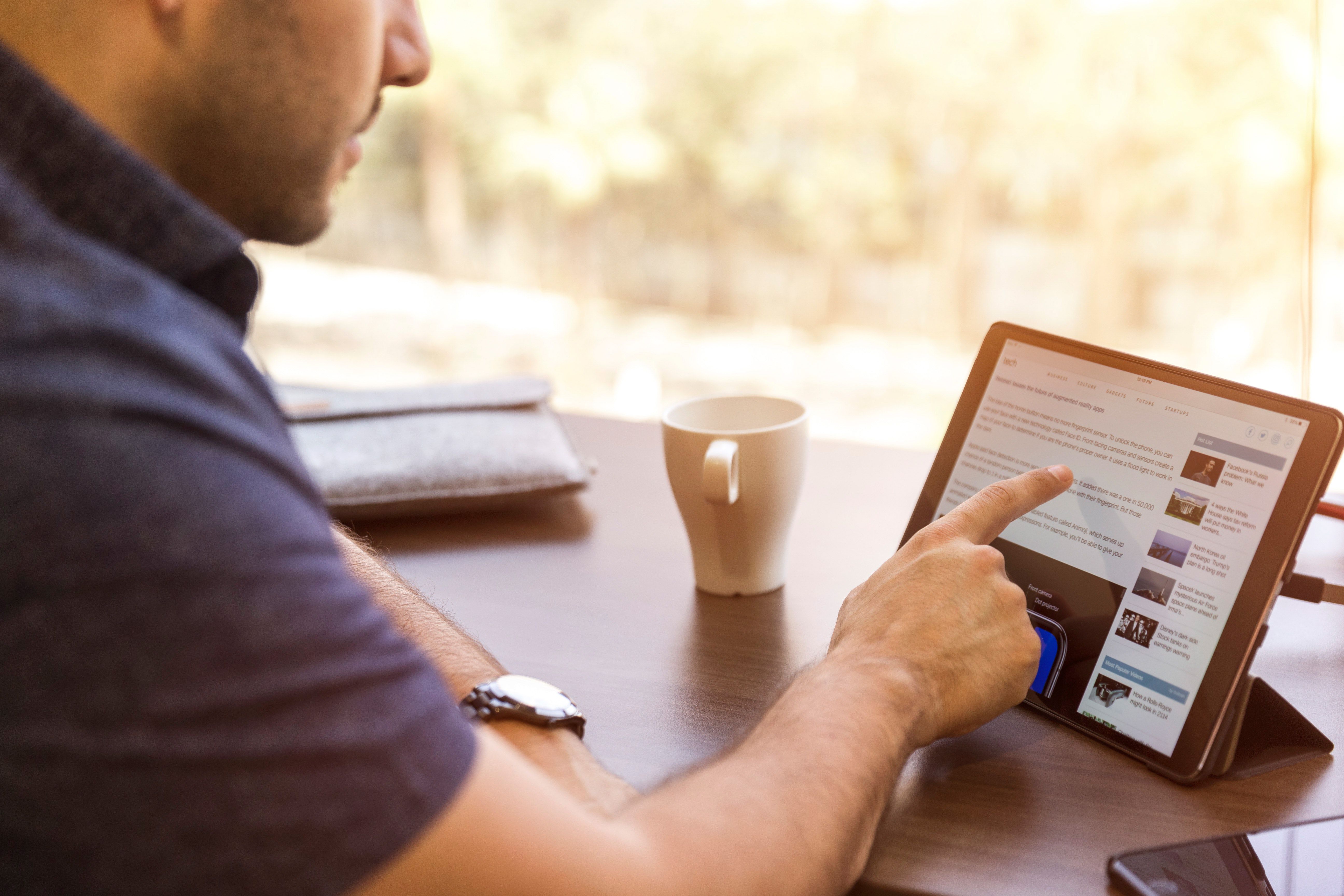 Man Browsing Tablet