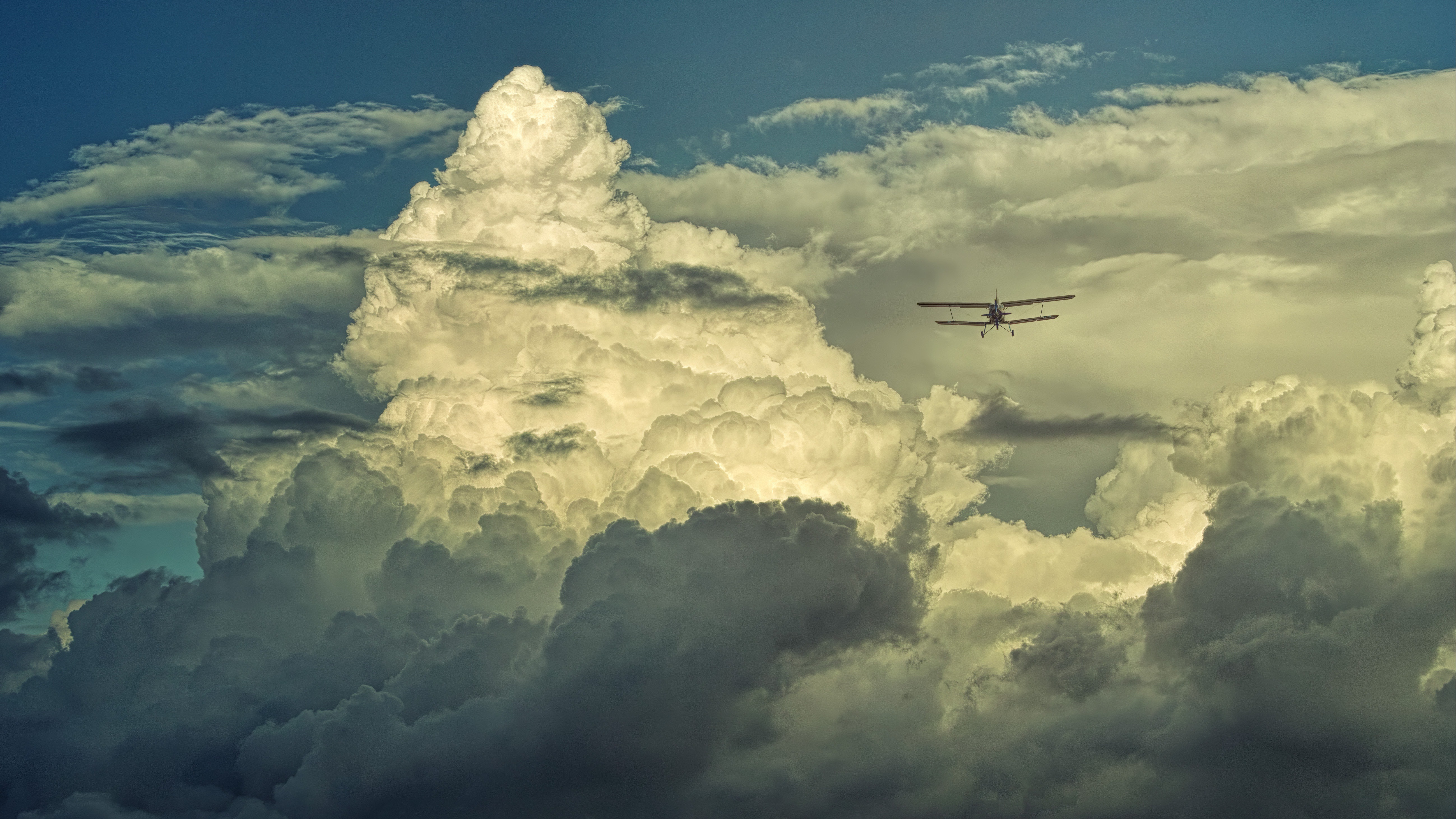 negative-space-small-prop-plane-flying-clouds-sky-johannes-plenio.jpg