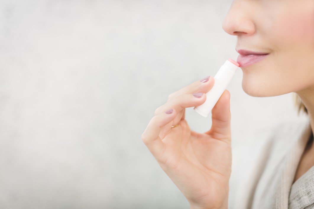 Woman Applying Lipstick