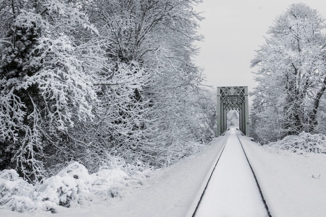 negative-space-fresh-snow-train-tracks-trees-1062x708.jpg