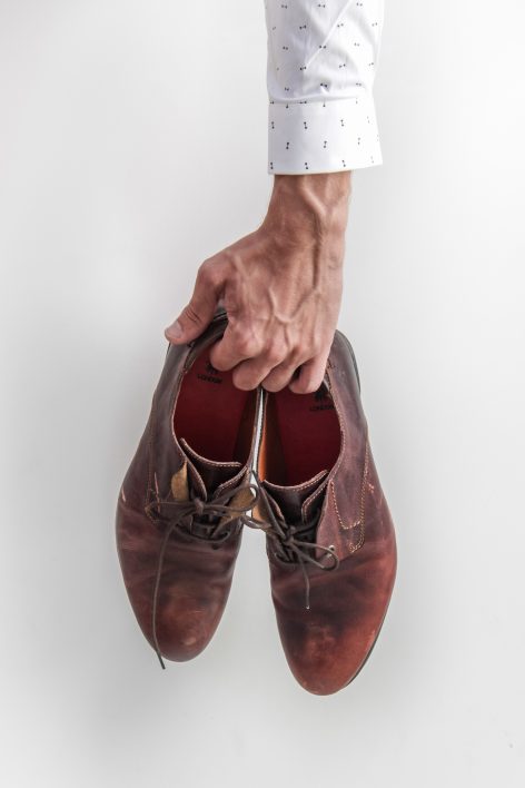 Man Holding Shoes