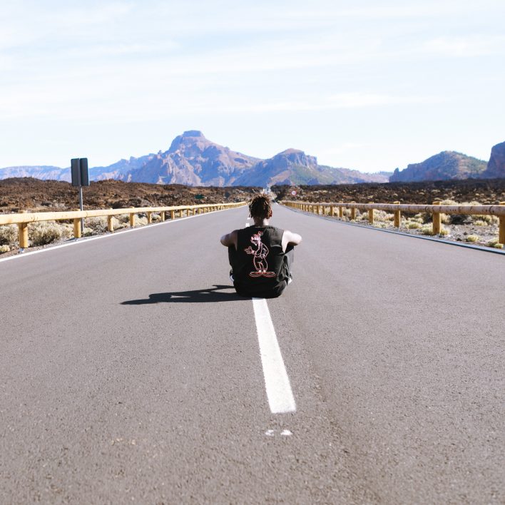 Man sitting in empty road