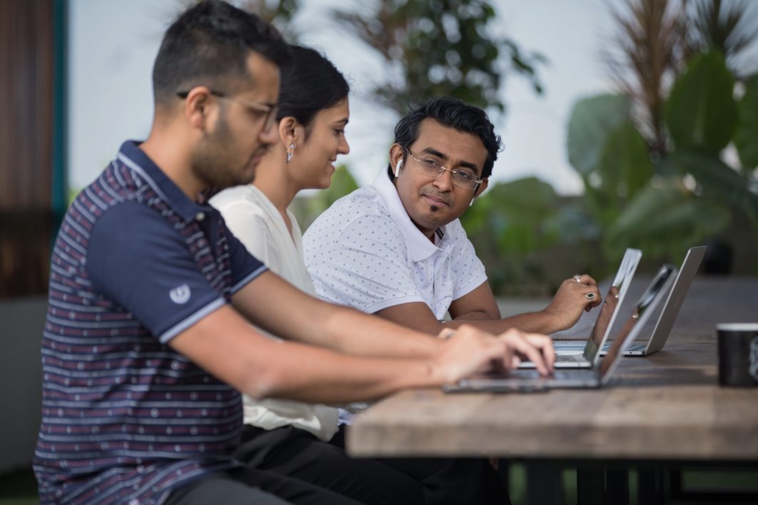 Colleagues Meeting Laptops