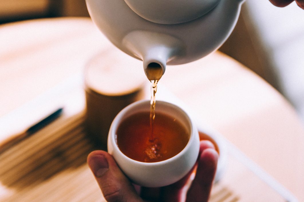 Hands Pouring Tea