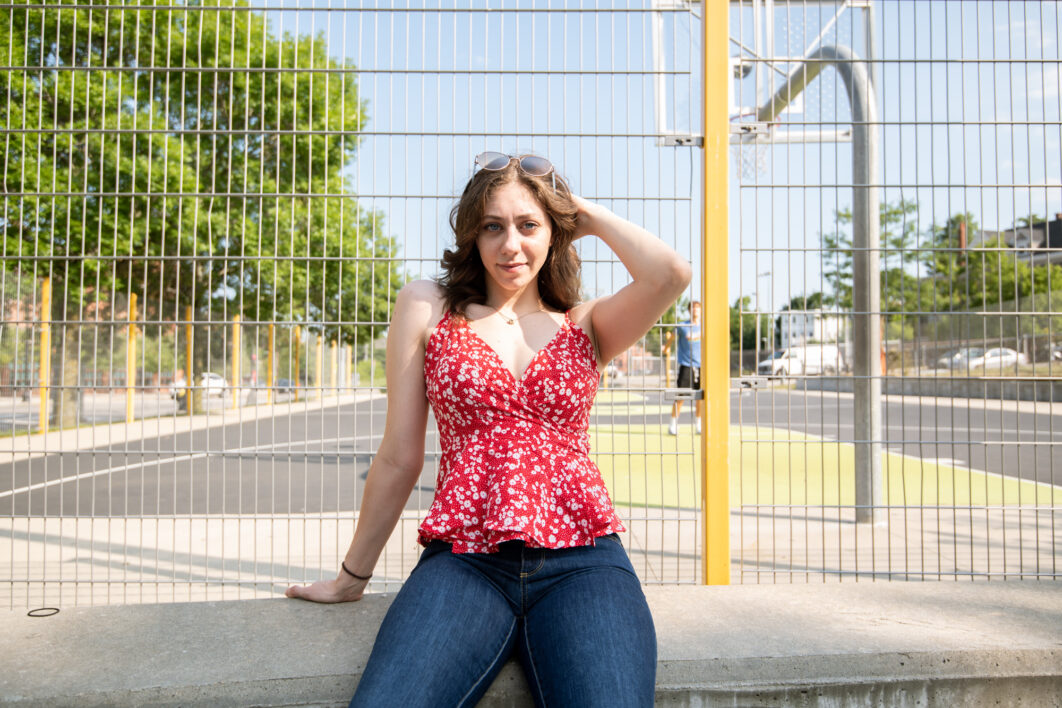 Fashion Hipster Cool Girl Relaxing On City Street. Pensive Female