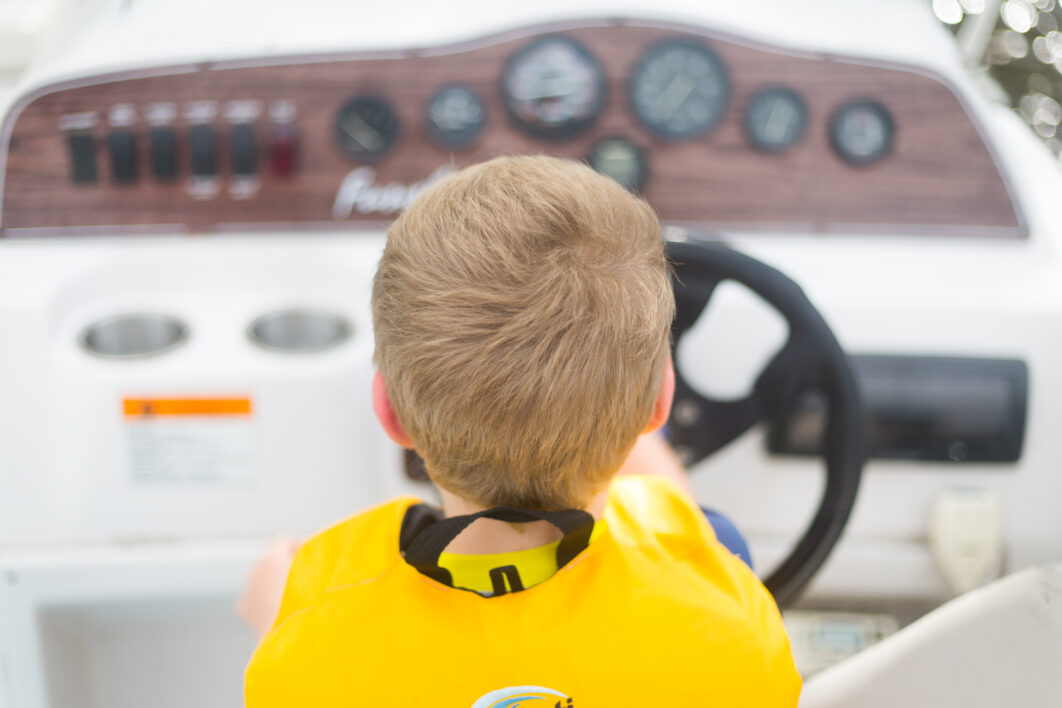 Child Driving Boat